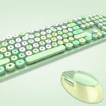 Pastel-green keyboard with round keys and a matching wireless mouse on a pale mint background.