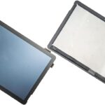Two laptop screens separated at a hinge with exposed connectors on a white background showing a broken or disassembled display setup